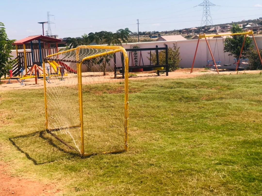 Fenced playground with goal posts